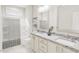 Contemporary bathroom featuring marble countertops, large mirrors, and a shower with tub at 2404 Adrift Rd, Fuquay Varina, NC 27526