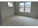 Bright, empty bedroom with a large window, providing lots of natural light, and closet space at 2404 Adrift Rd, Fuquay Varina, NC 27526