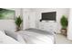 Bright bedroom featuring neutral colored walls and bedding, television, and decor at 2404 Adrift Rd, Fuquay Varina, NC 27526