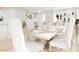 Bright dining room open to the living room features a large dining table and modern decor at 2404 Adrift Rd, Fuquay Varina, NC 27526