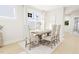 Bright dining room features large windows, modern chandelier, and seating for six at 2404 Adrift Rd, Fuquay Varina, NC 27526
