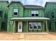 New construction home featuring green weather barrier, white windows, and covered front porch at 2404 Adrift Rd, Fuquay Varina, NC 27526