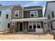 Charming two-story home featuring stone accents, two-tone siding, and a covered front porch at 2404 Adrift Rd, Fuquay Varina, NC 27526