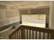 Unfinished garage with cement walls and floors, a wooden staircase, and an open garage door with a view of the street at 2404 Adrift Rd, Fuquay Varina, NC 27526