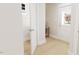 Hallway with hardwood floors, white trim, and natural light showcasing modern design at 2404 Adrift Rd, Fuquay Varina, NC 27526