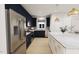 Modern kitchen featuring a large island, navy cabinets, and stainless steel appliances at 2404 Adrift Rd, Fuquay Varina, NC 27526
