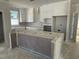 Spacious kitchen features white cabinets, ample counter space, and a large center island, perfect for cooking at 2404 Adrift Rd, Fuquay Varina, NC 27526