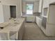 Well-lit kitchen with white cabinets and an island, providing lots of storage and food prep space at 2404 Adrift Rd, Fuquay Varina, NC 27526