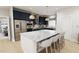 Modern kitchen featuring a large island, navy cabinets, and stainless steel appliances at 2404 Adrift Rd, Fuquay Varina, NC 27526
