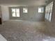 Spacious living room with large windows, offering lots of natural light, creating an inviting living space at 2404 Adrift Rd, Fuquay Varina, NC 27526