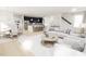 Open-concept living room seamlessly connects to the kitchen, featuring modern decor, hardwood floors, and natural light at 2404 Adrift Rd, Fuquay Varina, NC 27526
