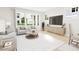 Bright living room with large windows, modern furniture, and hardwood floors at 2404 Adrift Rd, Fuquay Varina, NC 27526
