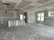 Spacious living room displaying drywall, recessed lighting, and large windows for natural light at 2404 Adrift Rd, Fuquay Varina, NC 27526