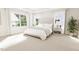 Inviting main bedroom features large windows and a tufted headboard with a plant accent at 2404 Adrift Rd, Fuquay Varina, NC 27526