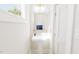 Stylish powder room features a pedestal sink, modern mirror, and decorative lighting at 2404 Adrift Rd, Fuquay Varina, NC 27526