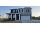 Charming two-story home boasts a two-car garage and inviting front porch at 111 Brodhead Dr, Fuquay Varina, NC 27526