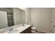 This modern bathroom features a double sink, a glass door shower, and wood-look flooring at 159 Robert Howe Dr, Fuquay Varina, NC 27526