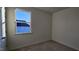 This bedroom provides a serene space with a large window offering views of the neighborhood at 159 Robert Howe Dr, Fuquay Varina, NC 27526