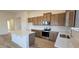 Kitchen featuring wood cabinets, stainless steel appliances, a subway tile backsplash, and an island at 159 Robert Howe Dr, Fuquay Varina, NC 27526