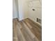 The laundry room features wood-look floors and utility connections, making it both stylish and functional at 159 Robert Howe Dr, Fuquay Varina, NC 27526