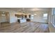 Bright, open-concept living area with hardwood floors connecting to kitchen and lots of light at 159 Robert Howe Dr, Fuquay Varina, NC 27526