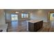 Open-concept living area with hardwood floors, large windows, and access to the kitchen at 159 Robert Howe Dr, Fuquay Varina, NC 27526