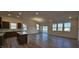 Bright, open-concept living area with hardwood floors connecting to kitchen and lots of light at 159 Robert Howe Dr, Fuquay Varina, NC 27526