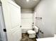 Bathroom with white tiled shower, bronze fixtures, and toilet at 315 Bishop Ln, Sanford, NC 27330