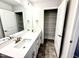 Bathroom with a double sink vanity, large mirror, and an adjacent linen closet for storage at 315 Bishop Ln, Sanford, NC 27330