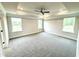 A spacious bedroom with carpet and three windows at 315 Bishop Ln, Sanford, NC 27330
