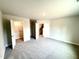Bedroom with carpet and open doors to closet and hallway at 315 Bishop Ln, Sanford, NC 27330