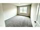 Bright, carpeted bedroom with a window offering an outside view and natural light at 315 Bishop Ln, Sanford, NC 27330