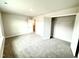 Bedroom with neutral carpet, white walls, and a closet with built-in shelving for storage at 315 Bishop Ln, Sanford, NC 27330