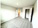 Open bedroom with neutral carpet, connecting doorway, and closet with shelving at 315 Bishop Ln, Sanford, NC 27330