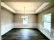 Dining room featuring tray ceiling, chair rail, and elegant chandelier at 315 Bishop Ln, Sanford, NC 27330