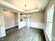 Dining room with wainscoting, dark floors, and chandelier at 315 Bishop Ln, Sanford, NC 27330
