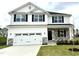 New two-story home with white siding, black shutters, stone accents, and a two-car garage at 315 Bishop Ln, Sanford, NC 27330