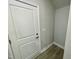 Hallway to the garage with luxury vinyl plank flooring, white door, and neutral paint at 315 Bishop Ln, Sanford, NC 27330