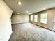 Spacious living room with plush carpet and multiple windows for natural light at 315 Bishop Ln, Sanford, NC 27330