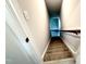 Carpeted staircase with wooden handrail provides a transition between floors at 315 Bishop Ln, Sanford, NC 27330