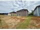 View of the backyard featuring new construction homes, showcasing lot size and neighborhood at 324 Bishop Ln, Sanford, NC 27330