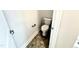 Powder room featuring vinyl flooring and a toilet at 324 Bishop Ln, Sanford, NC 27330