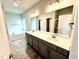 Primary bath with double vanity, quartz countertop, soaking tub, and tiled walk-in shower at 324 Bishop Ln, Sanford, NC 27330