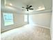 Spacious bedroom with neutral carpet, ceiling fan, recessed lighting, and double windows at 324 Bishop Ln, Sanford, NC 27330