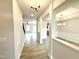 Inviting entryway showcasing open-concept design with pristine finishes and modern lighting fixtures at 324 Bishop Ln, Sanford, NC 27330