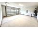 Spacious two car garage with newly painted walls, a sealed concrete floor and garage door with windows at 324 Bishop Ln, Sanford, NC 27330