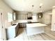 Bright, modern kitchen with grey cabinets, stainless steel appliances, and a central island at 324 Bishop Ln, Sanford, NC 27330