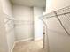 Walk-in closet with carpet flooring and custom shelving for storage at 324 Bishop Ln, Sanford, NC 27330