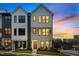 Modern three-story townhome with gray and white exterior, showcasing a stylish design at 710 W North St # 101, Raleigh, NC 27603