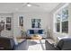 Light-filled living room with gray sofas and a round coffee table at 710 W North St # 101, Raleigh, NC 27603